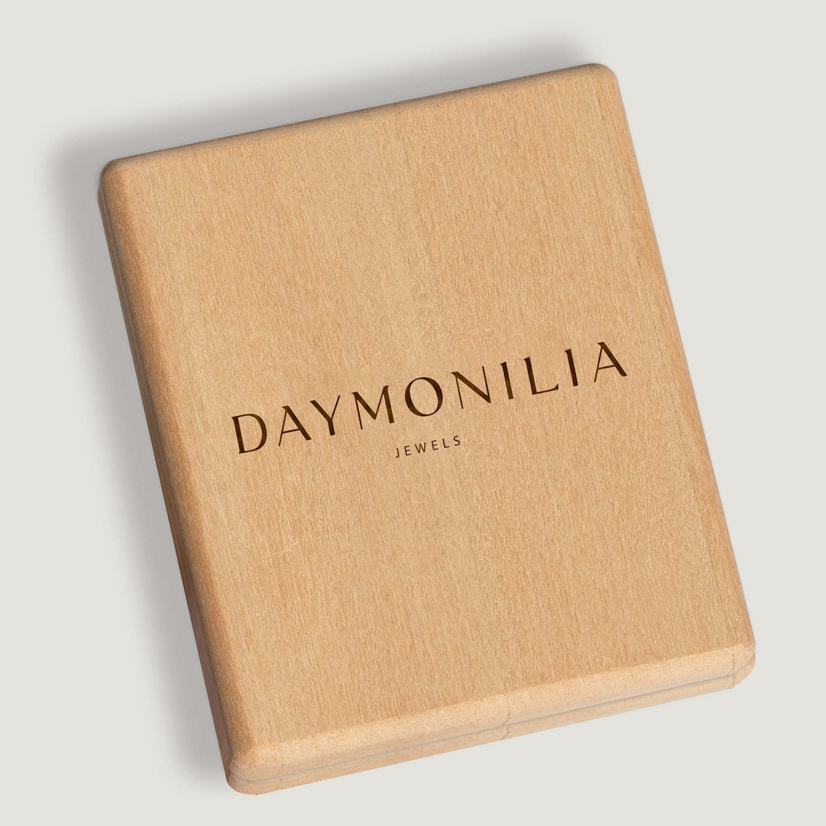 The light wooden box of the House, closed, with the name Daymonilia in gold leaf.
